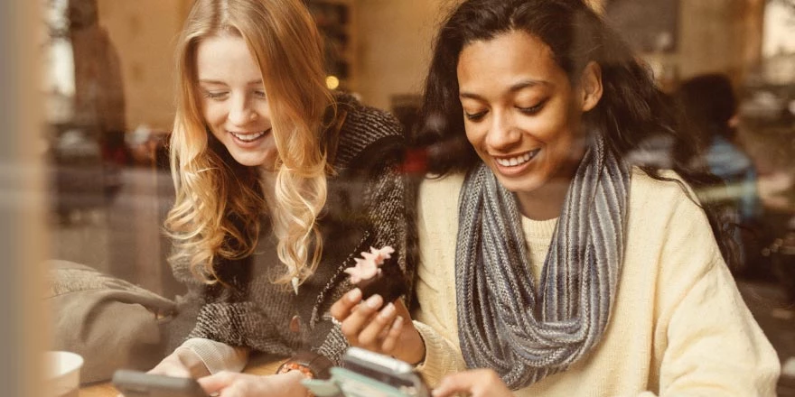 Two friends having coffee together