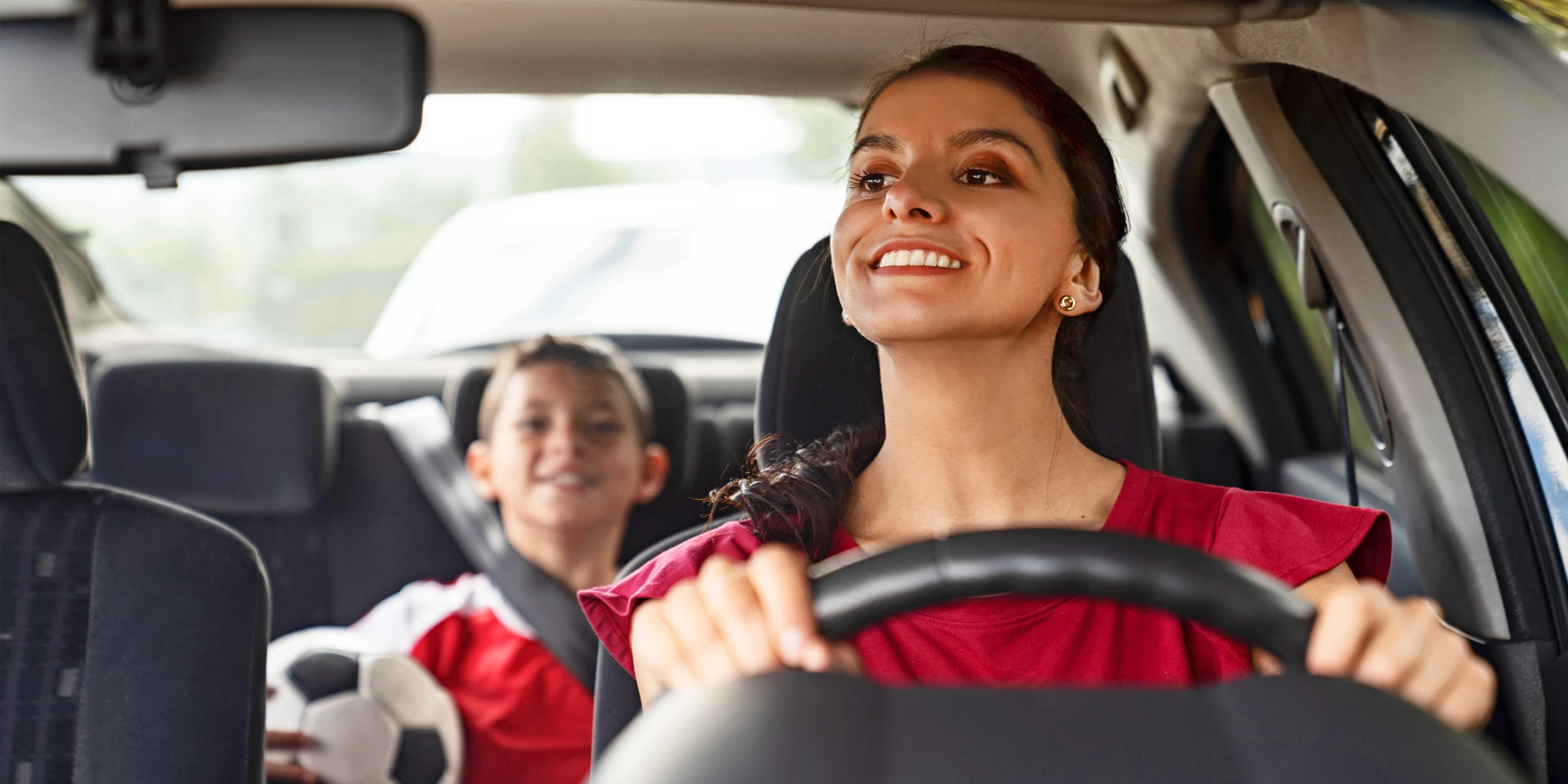 A mom driving her son to a soccer game.