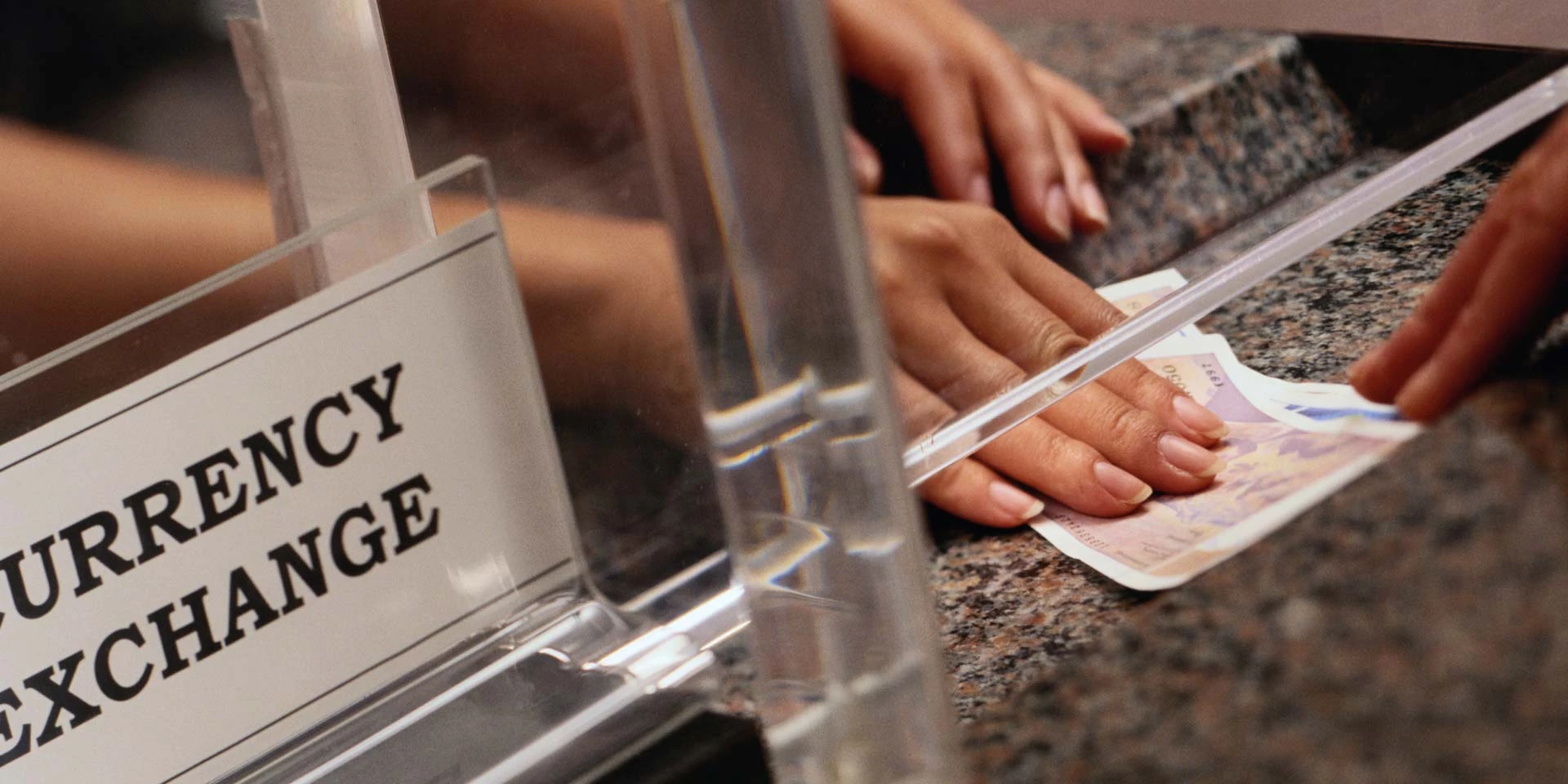 Close up of money being exchanged at a money service business and financial service center