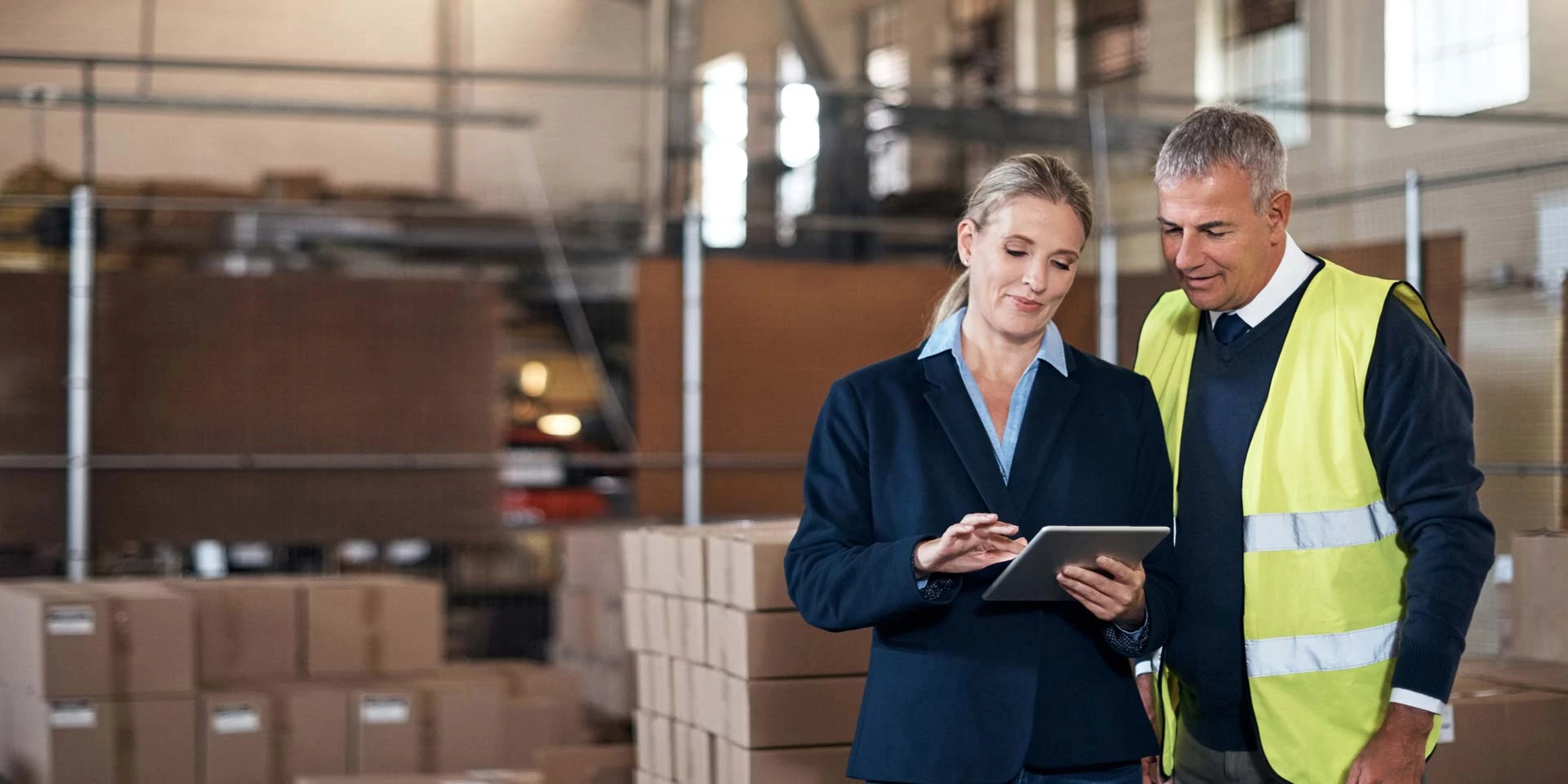 A business owner and warehouse manager discuss purchases made and financing received from an asset based lending program