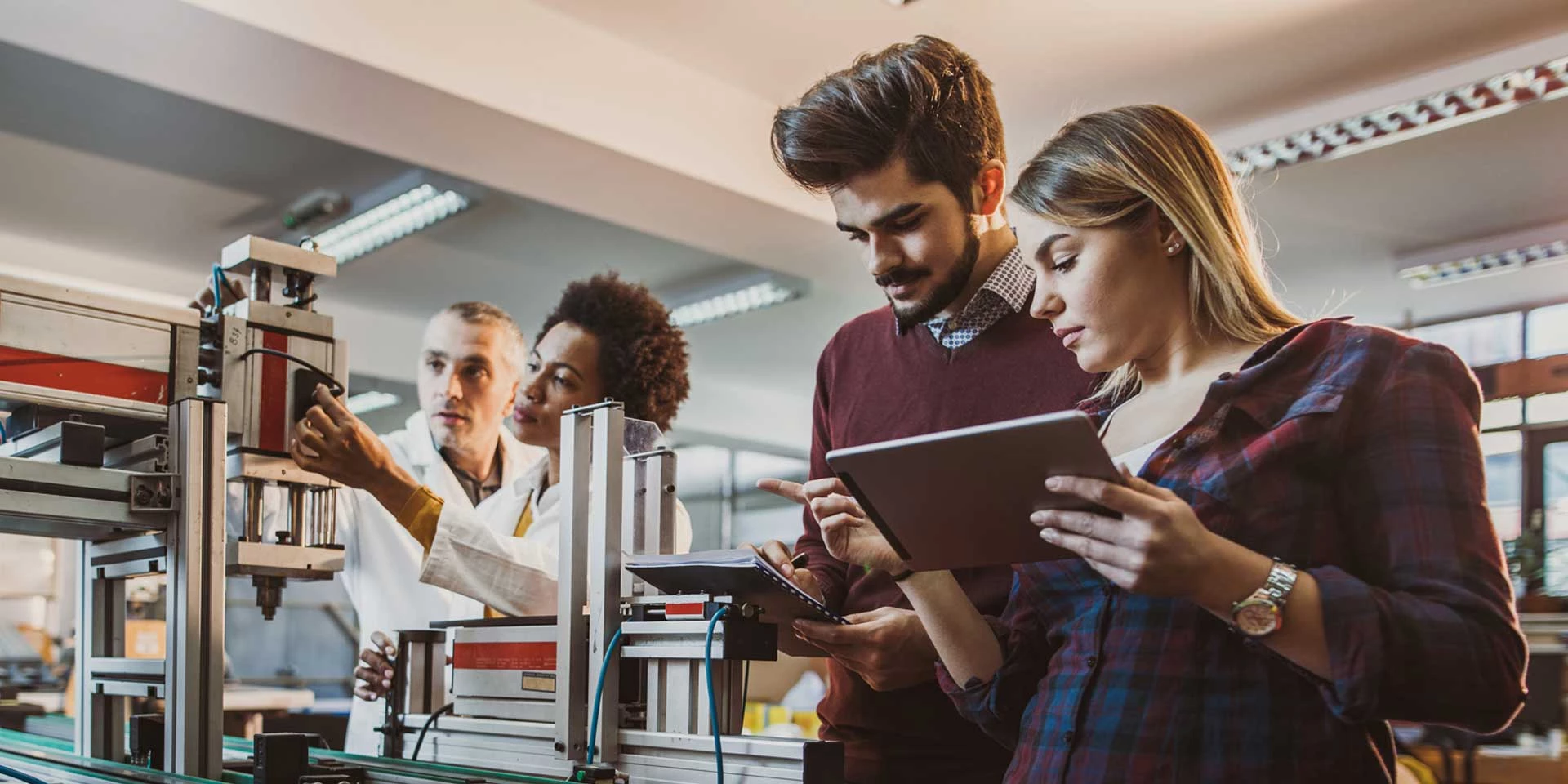 A team of researchers work in their production lab after receiving business cash flow through a structured finance program