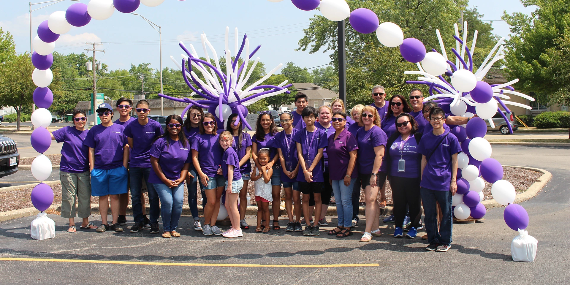 A large group of First Midwest Bank employees and family members are volunteering at a community event