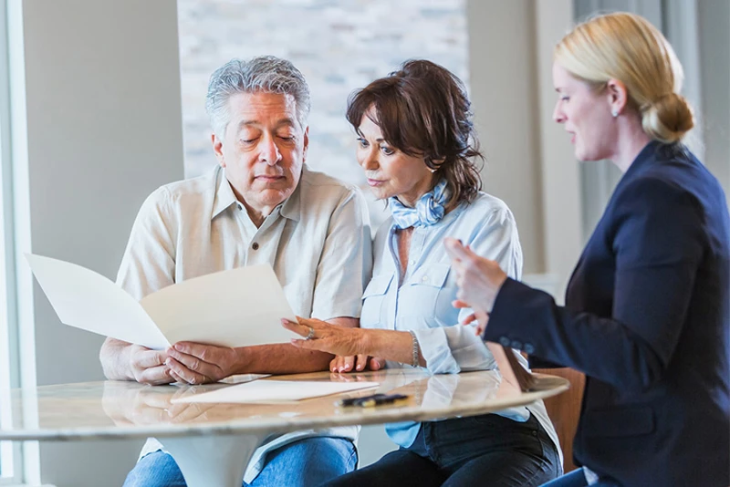 A banker helping a client with the new merger information