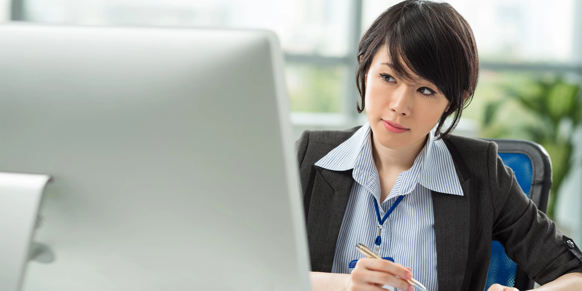 Woman behind a computer screen