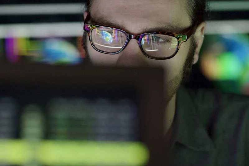 Close up of a businessman focused on his computer screen showing interest rate swaps