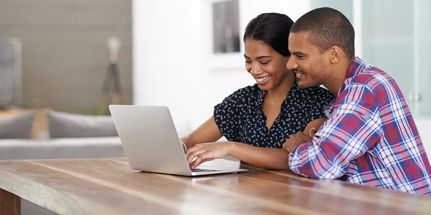 Young couple making an online payment on their laptop.