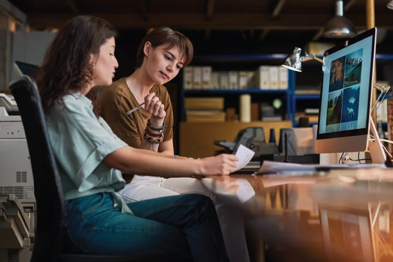 Two small business owners working behind a computer