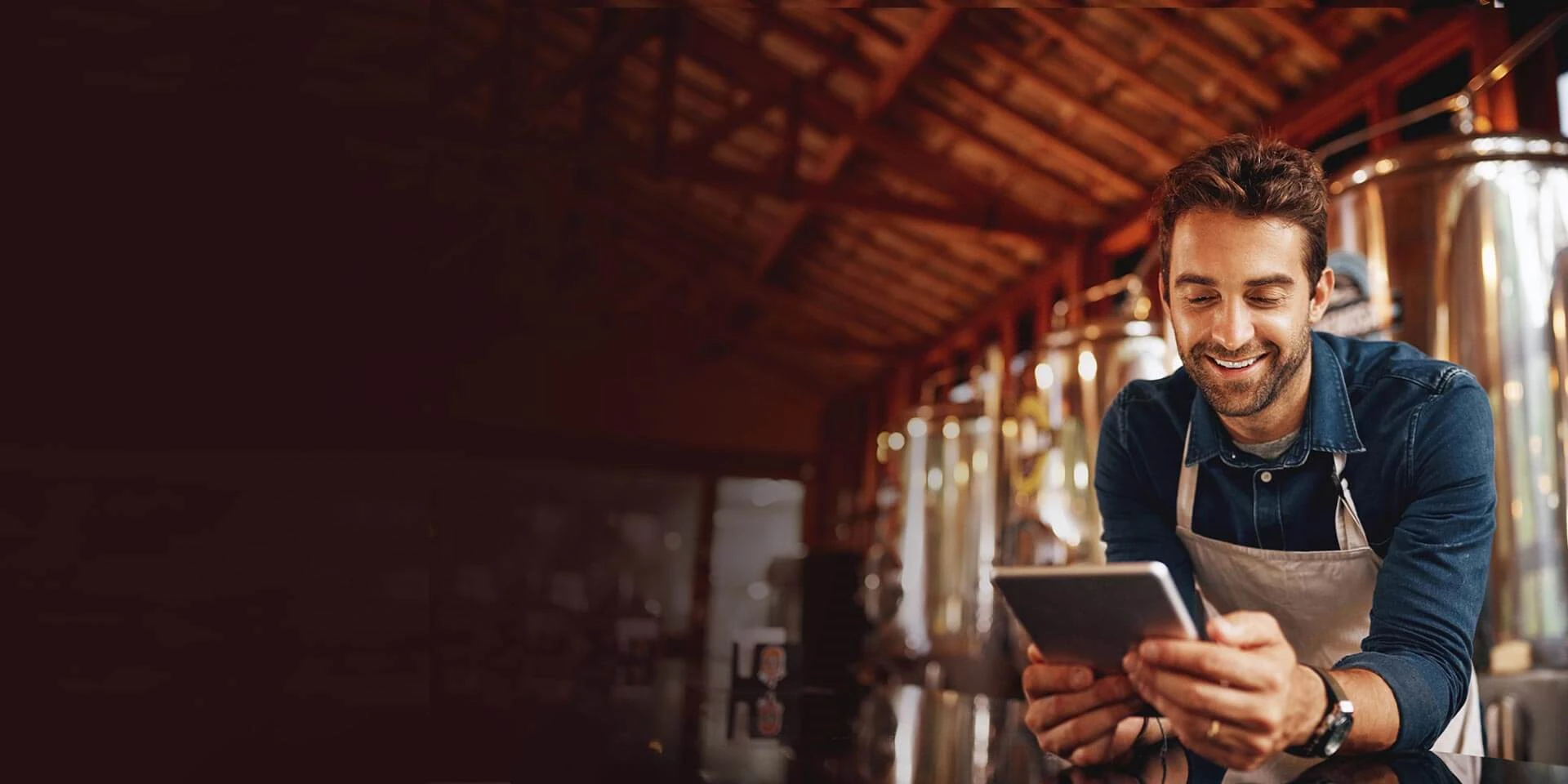 A business owner looks at his tablet and explores the business loan and line of credit options that are available